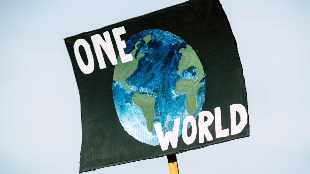 Graphic of a sign stating, "ONE WORLD."