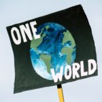 Graphic of a sign stating, "ONE WORLD."