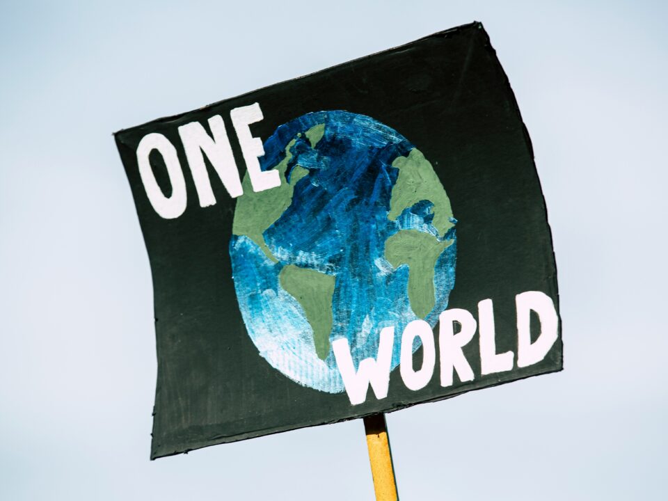 Graphic of a sign stating, "ONE WORLD."