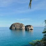 Image of Mismaloya Arches in Mexico surround by a body of open ocean.