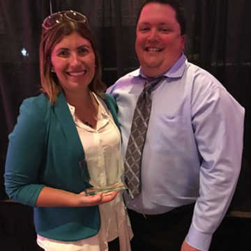 Picture taken of PME CEO, Kristin Elliott and colleague holding the “Women Who Mean Business,” award.