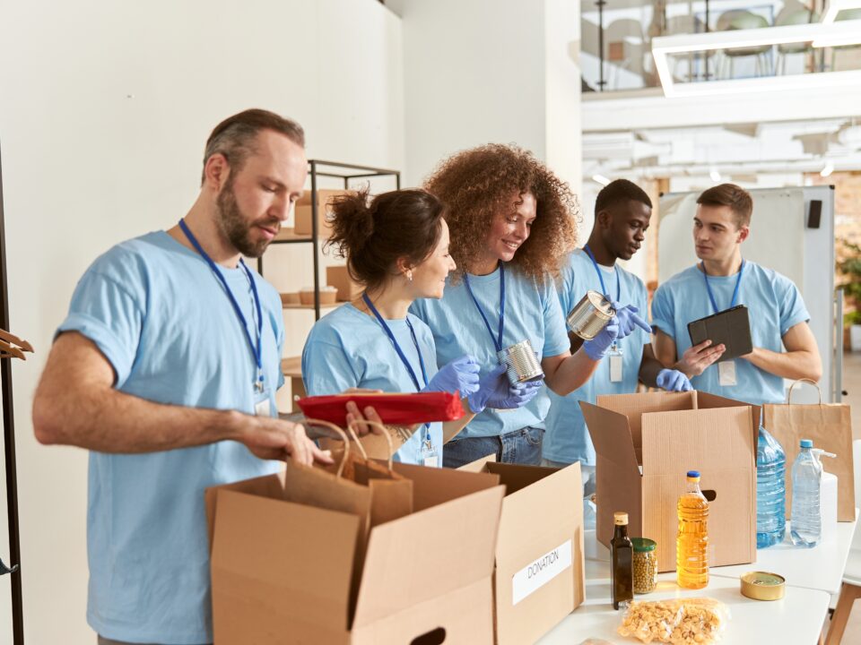 Diverse team of volunteers assembling care packages.