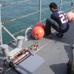 Researcher on deck by water